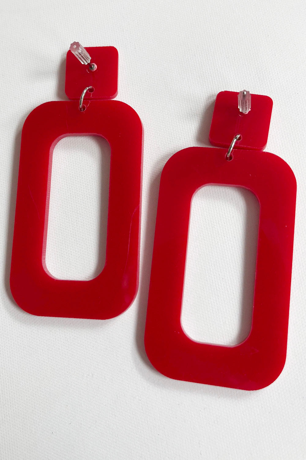 Vintage jaren 80 statement oorbellen rood achterkant - detail van plastic oorbellen achterzijde