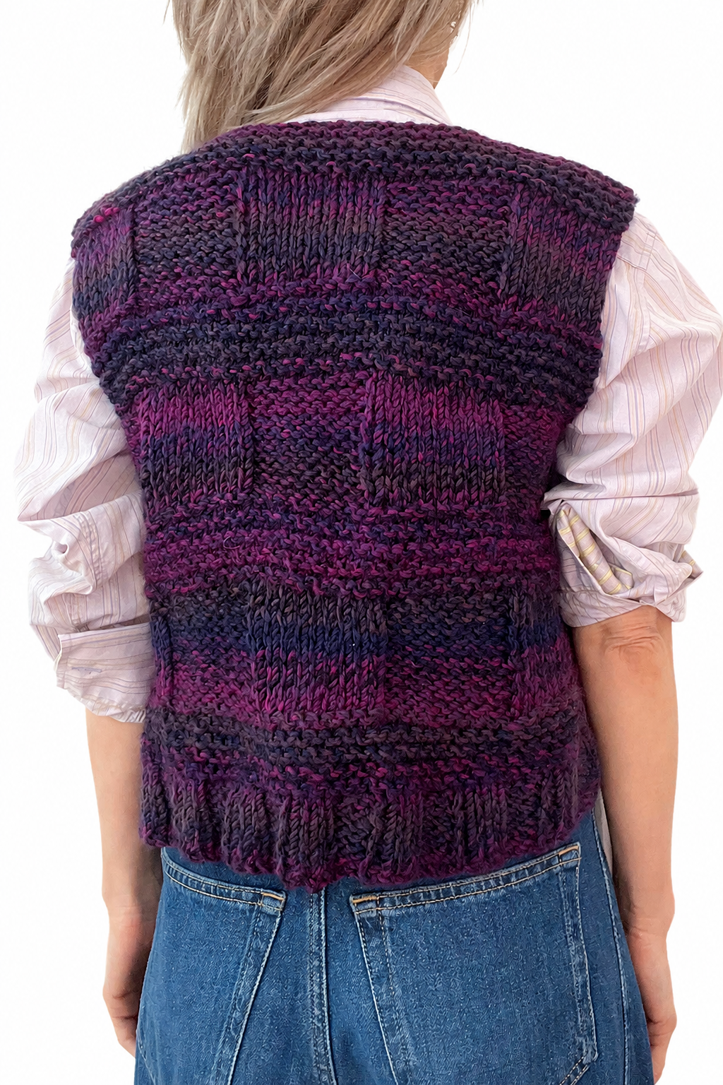 Achterkant van vintage jaren 70 mouwloos vest met afwisselende gebreide vlakken in paars, roze en blauw.

