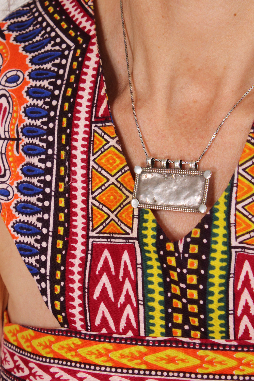 Vintage jaren 70 handgemaakte dashiki halterjurk oranje-multi - close-up van hals en stofstructuur

