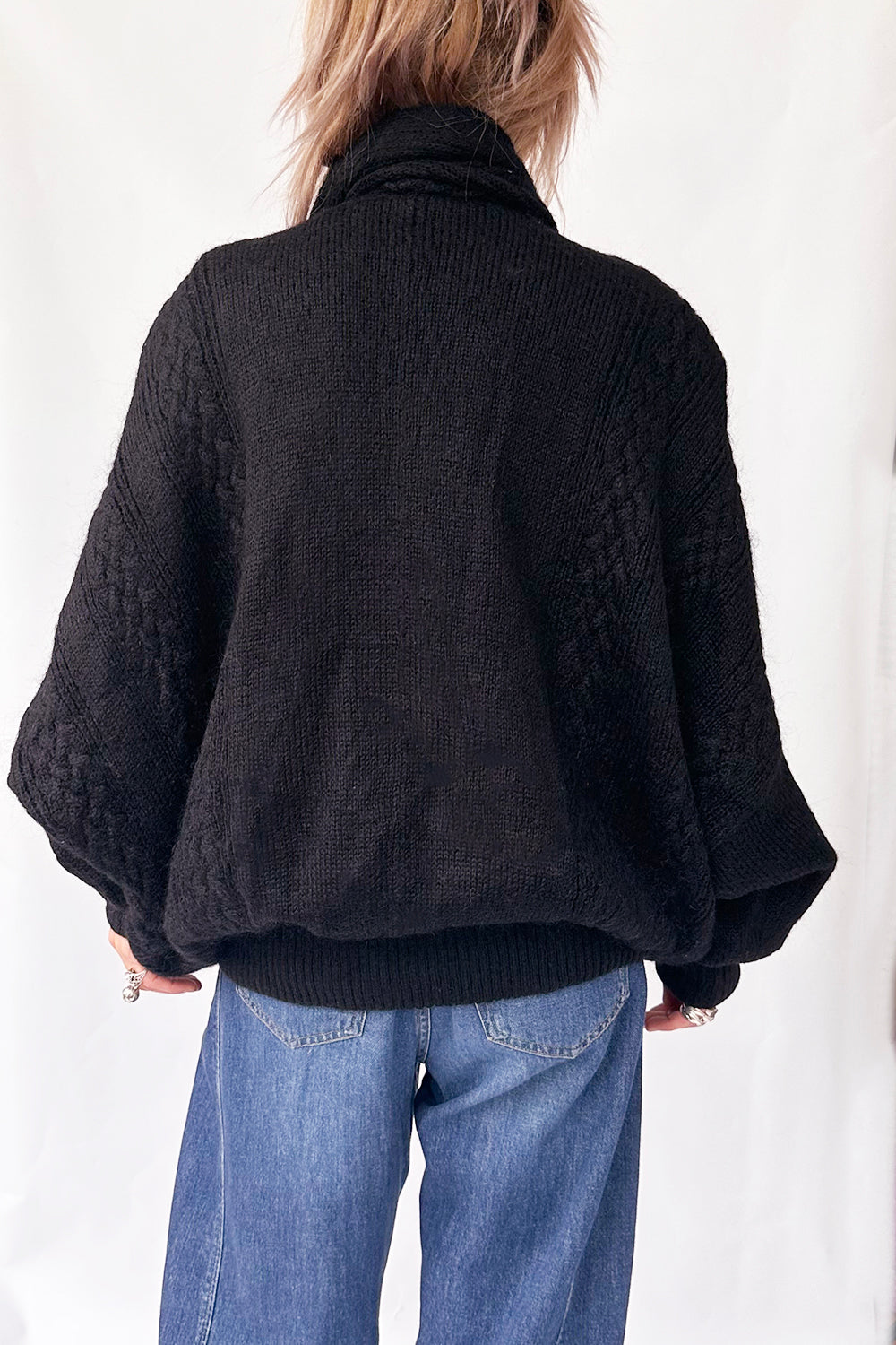 Achteraanzicht van vintage oversized 1980s gebreid vest met brede schouders en lange lengte
