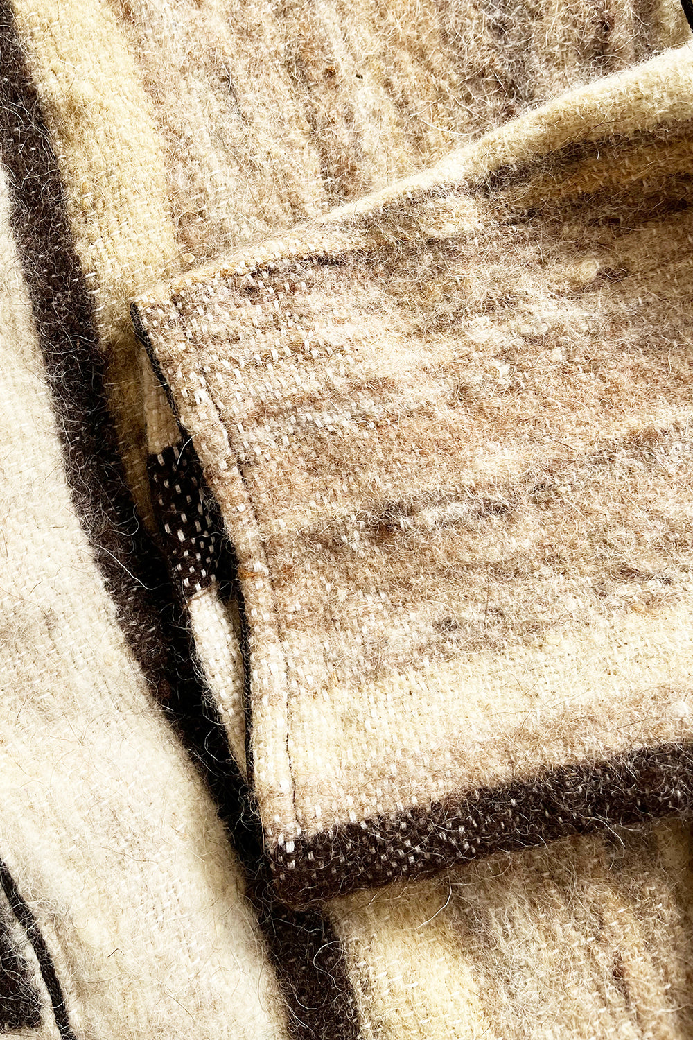 Detail van de mouw en afwerking van een opgestikte zak op de handgemaakte vintage blanket coat.
